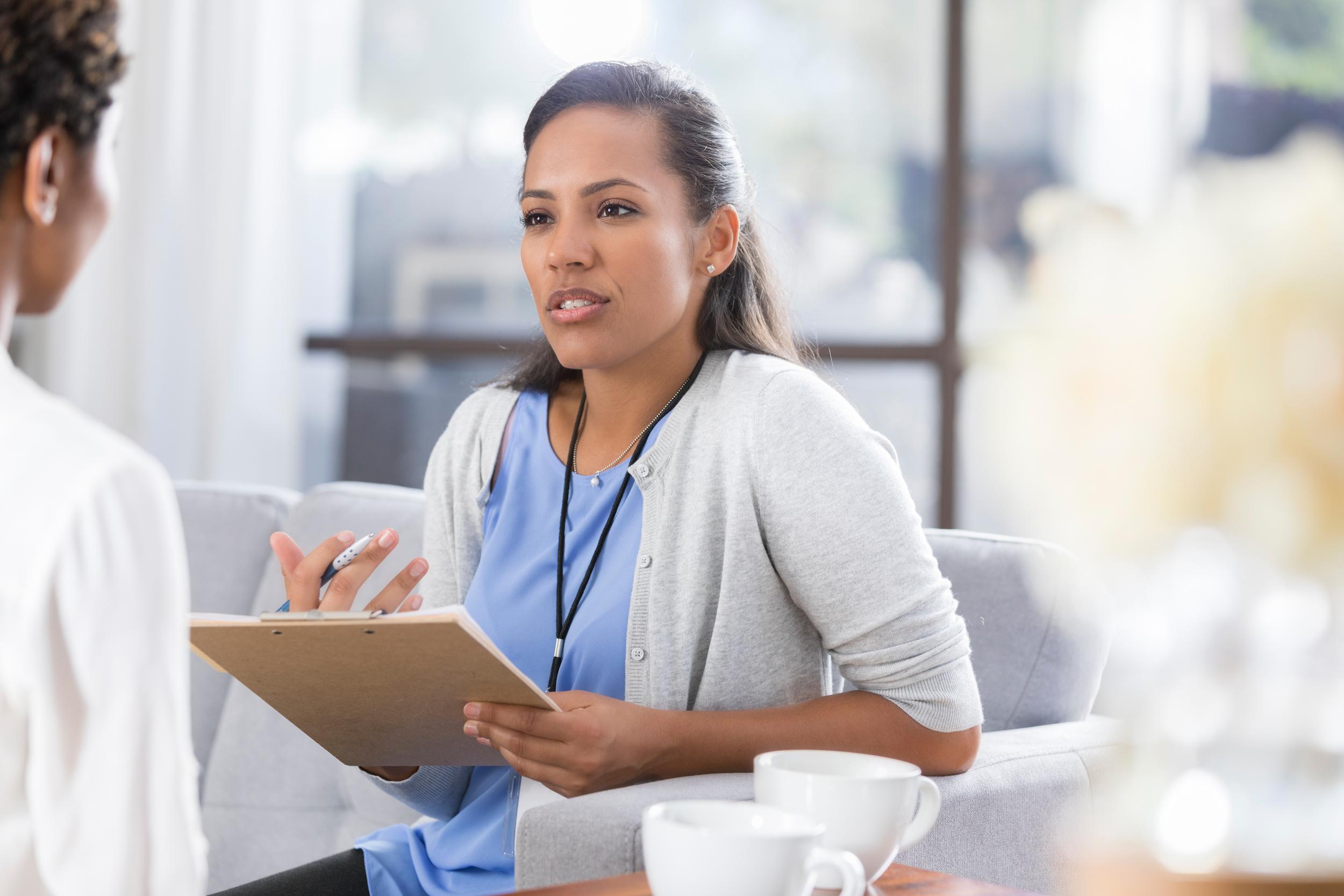 female psychiatrist discusses something with female patient